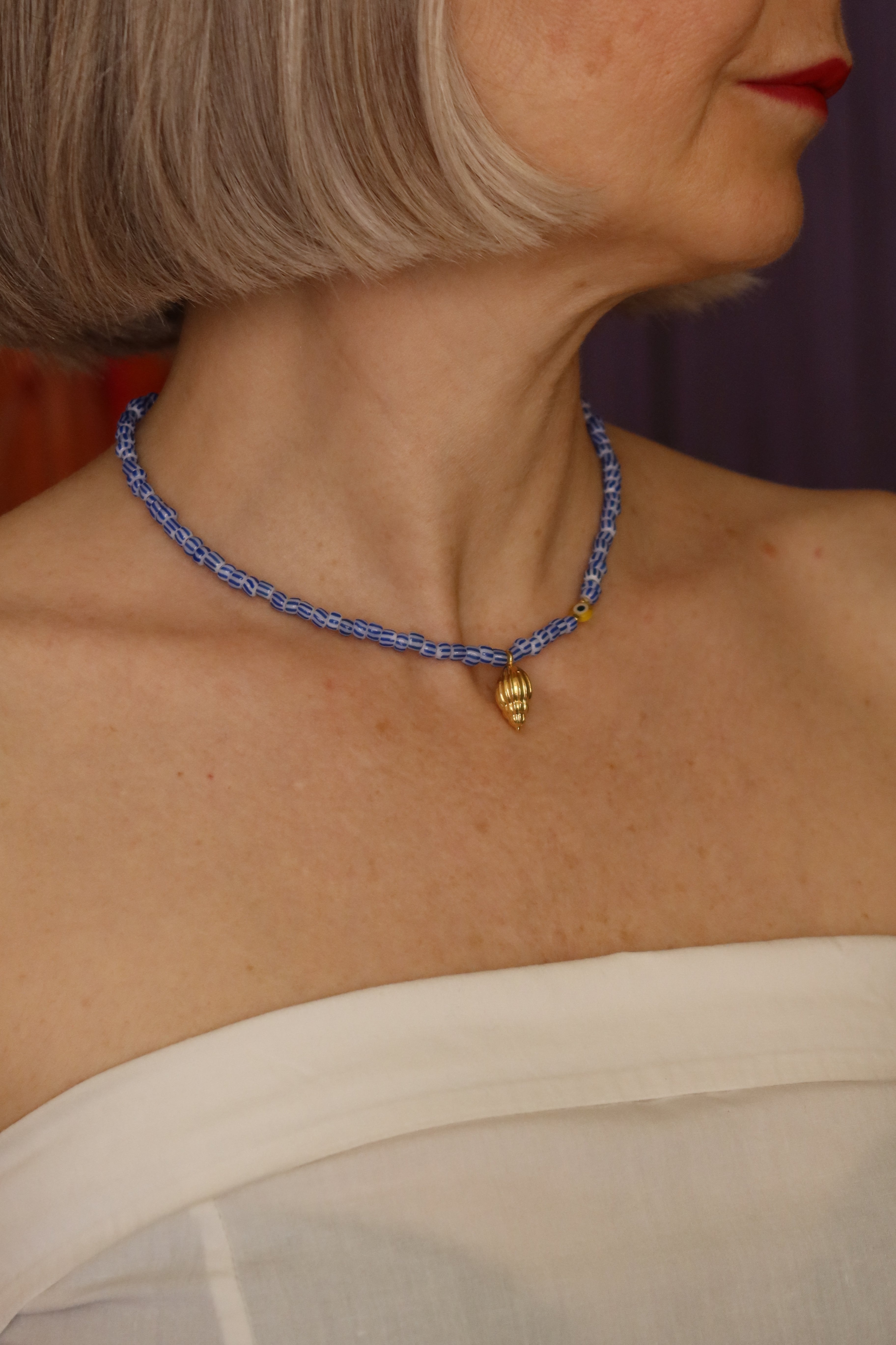 Collana con perline a righe bianche e blu e conchiglia dorata